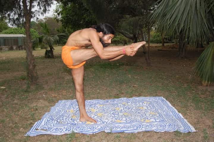 Acharya Ji in traditional orange robes